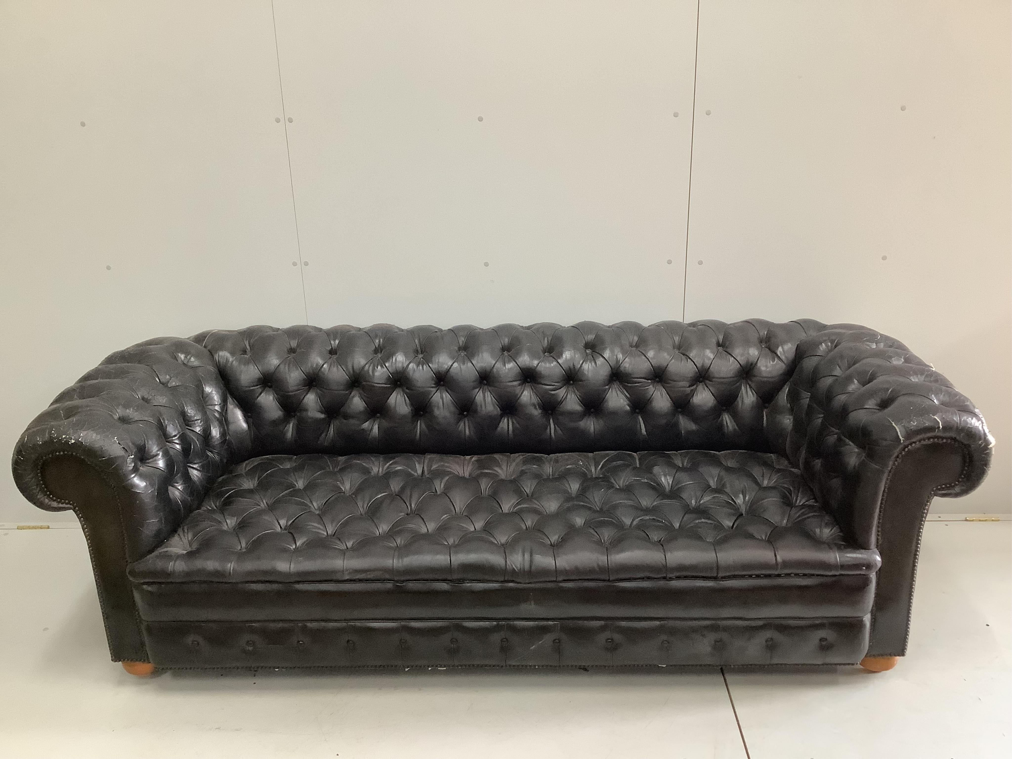 A Victorian style black leather button back chesterfield settee, width 230cm, depth 90cm, height 73cm. Condition - poor
